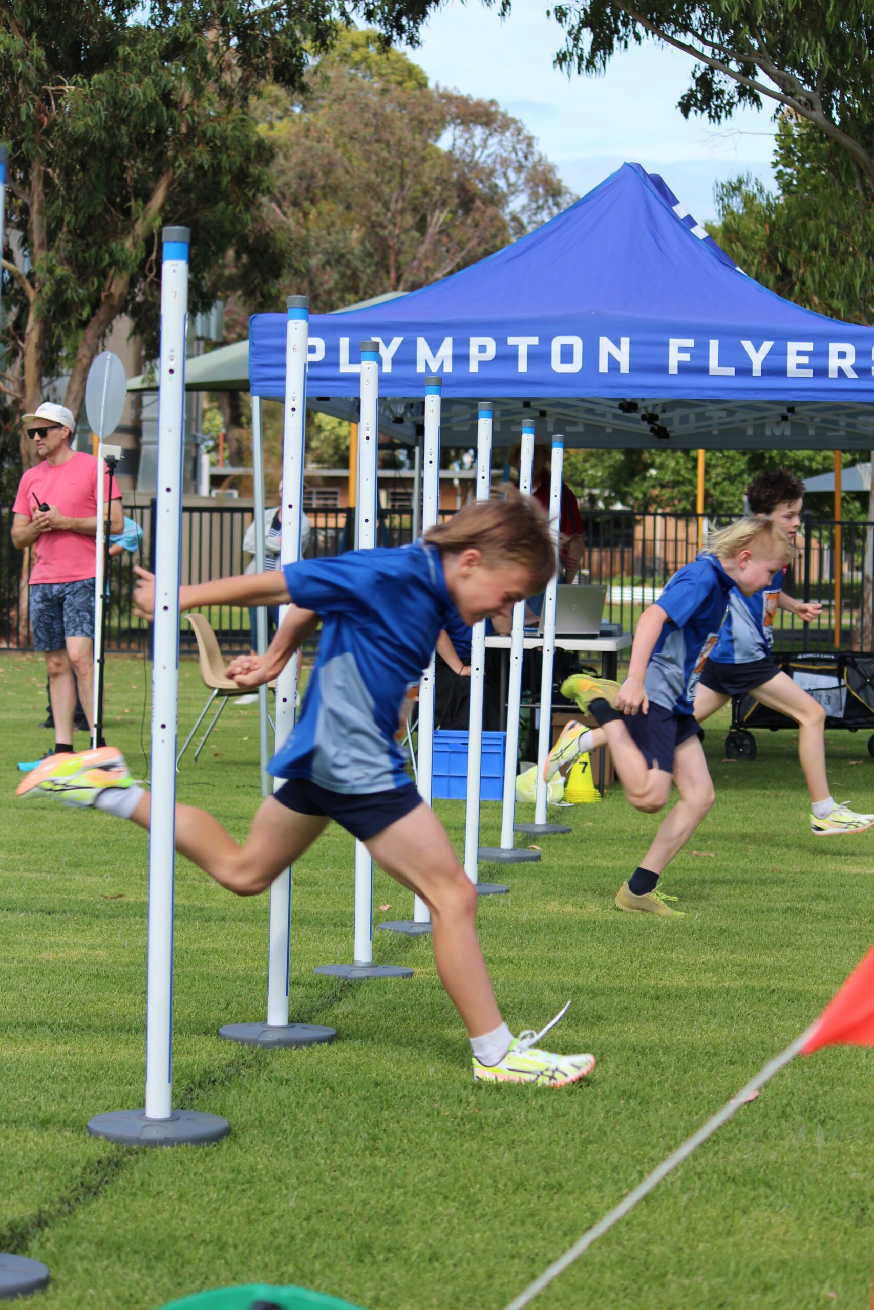 Athletes crossing the finish line through the Plympton Flyers electronic timing gates